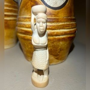 Vintage woman holding pot hand carved figurine